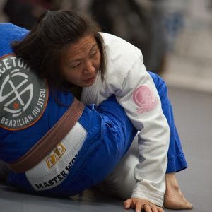 Emily Kwok rolling with a brown belt student