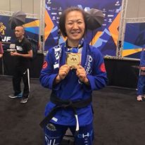 Emily Kwok smiles with her gold medal after competition
